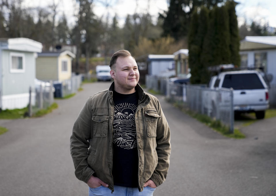 Resident and board member of the mobile home park Bob’s and Jamestown Homeowners Cooperative, Gadiel Galvez, 22, poses for a portrait in his neighborhood on Saturday, March 25, 2023, in Lakewood, Wash. When residents learned the park’s owner was looking to sell, they formed a cooperative and bought it themselves amid worries it would be redeveloped. Since becoming owners in September 2022, residents have worked together to manage and maintain the park. (AP Photo/Lindsey Wasson)