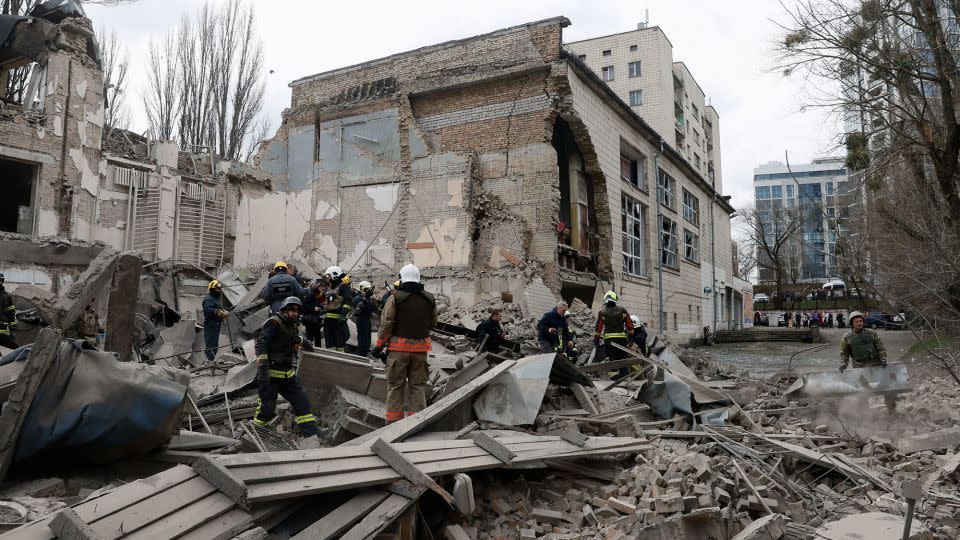 Rescuers workers sift through the rubble after Monday's hypersonic missile strike on Kyiv. - Gleb Garanich/Reuters