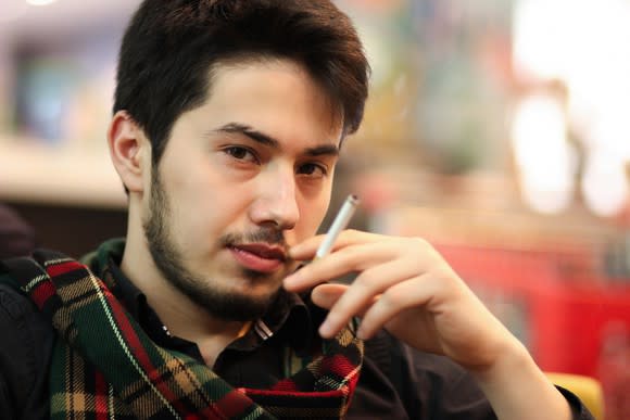 A young man smoking a cigarette.