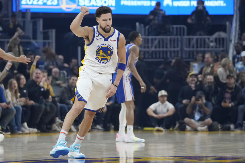 Golden State Warriors guard Klay Thompson (11) gestures after making a 3-point basket against the Philadelphia 76ers during the first half of an NBA basketball game in San Francisco, Friday, March 24, 2023. (AP Photo/Jeff Chiu)