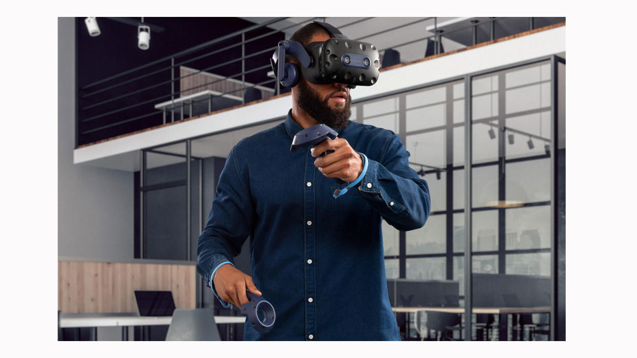  Image shows a man using the HTC Vive Pro 2 in an office. 