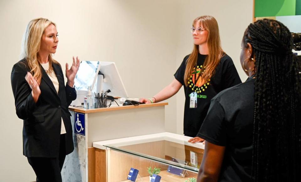 Trulieve’s CEO and founder Kim Rivers speaks with employees before the grand opening of the medical marijuana dispensary in Macon Friday morning.