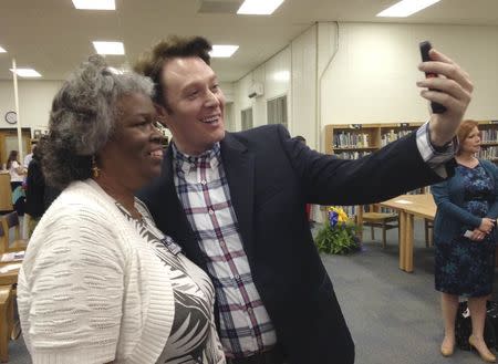 Democratic nominee Clay Aiken takes a pictures with a constituent after a campaign forum in Cary, North Carolina, April 28, 2014. REUTERS/Colleen Jenkins