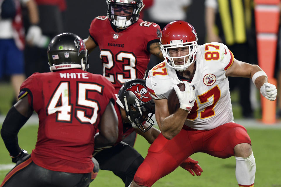 Kansas City Chiefs tight end Travis Kelce (87) eludes Tampa Bay Buccaneers strong safety Antoine Winfield Jr. (31) and inside linebacker Devin White (45) after a catch during the first half of an NFL football game Sunday, Nov. 29, 2020, in Tampa, Fla. (AP Photo/Jason Behnken)