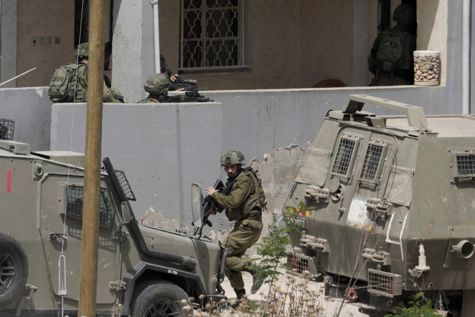 FILE - Israeli soldiers conduct an operation in the West Bank town of Jenin, Friday, May 13, 2022. Daoud Zubeidi, a Palestinian gunman who is the brother of a prominent jailed Palestinian militant died Sunday after being critically wounded in clashes with Israeli forces, according to the Israeli hospital where he was being treated. (AP Photo/Majdi Mohammed, File)