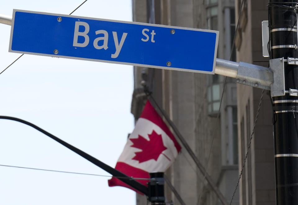 The Bay Street Financial District is shown with the Canadian flag in Toronto. THE CANADIAN PRESS/Nathan Denette