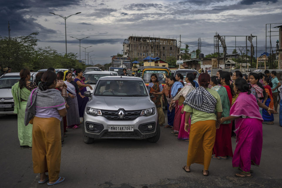 FILE- Members of Meira Paibis, powerful vigilante group of Hindu majority Meitei women, block traffic as they check vehicles for the presence of members from rival Christian tribal Kuki community, in Imphal, capital of the northeastern Indian state of Manipur, June 19, 2023. For three months, Indian Prime Minister Narendra Modi has been largely silent on ethnic violence that has killed over 150 people in Manipur. That's sparked a no-confidence motion against his government in Parliament, where his party and allies hold a clear majority. (AP Photo/Altaf Qadri, File)