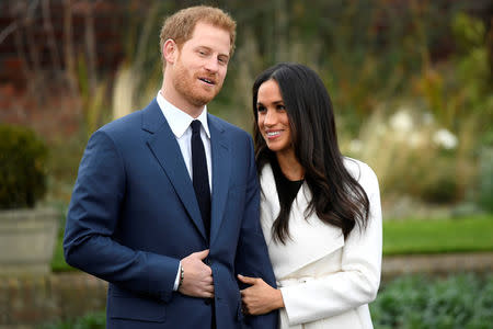 Britain's Prince Harry poses with Meghan Markle in the Sunken Garden of Kensington Palace, London, Britain, November 27, 2017. REUTERS/Toby Melville
