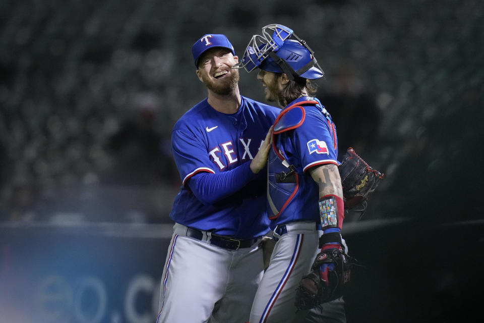 Texas Rangers pitcher Will Smith, left, celebrates with catcher Jonah Heim after the team's 4-0 victory over the Oakland Athletics in a baseball game in Oakland, Calif., Thursday, May 11, 2023. (AP Photo/Godofredo A. Vásquez)
