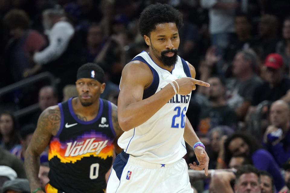 Dallas Mavericks guard Spencer Dinwiddie (26) points after a three pointer against the Phoenix Suns during the first half of Game 7 of an NBA basketball Western Conference playoff semifinal, Sunday, May 15, 2022, in Phoenix. The Mavericks defeated the Suns 123-90. (AP Photo/Matt York)