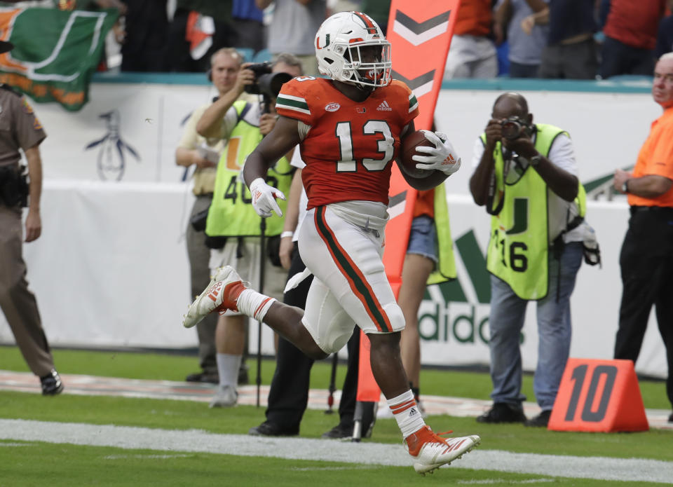 Miami running back DeeJay Dallas (13) runs win for a touchdown on a punt return during the first half of an NCAA college football game against Pittsburgh, Saturday, Nov. 24, 2018, in Miami Gardens, Fla. (AP Photo/Lynne Sladky)