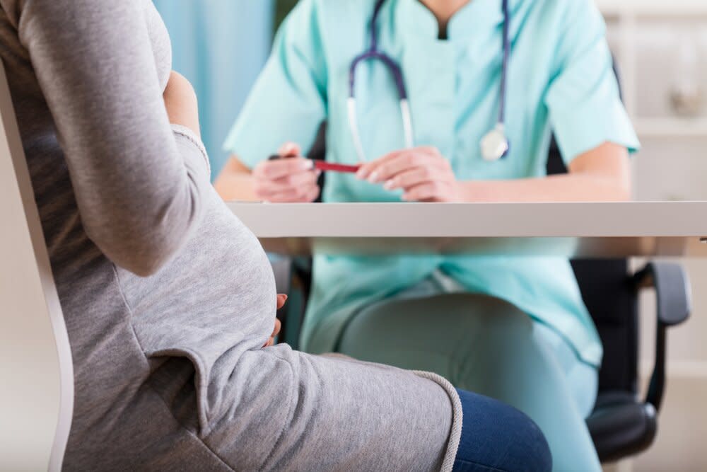 Pregnant woman talking to doctor