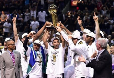Jun 15, 2014; San Antonio, TX, USA; The San Antonio Spurs celebrate with the Larry O'Brien Trophy after game five of the 2014 NBA Finals against the Miami Heat at AT&T Center. The Spurs beat the Heat 104-87 to win the NBA Finals. Bob Donnan-USA TODAY Sports