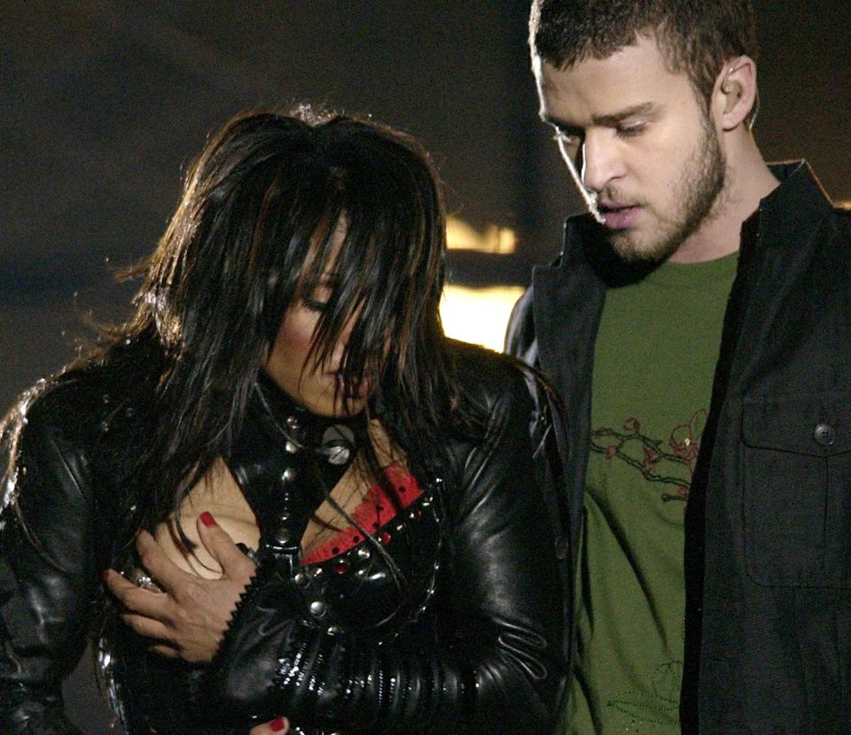 FILE - In this Sunday Feb. 1, 2004 file photo, entertainer Janet Jackson, left, covers her breast after her outfit came undone during the halftime performance with Justin Timberlake at Super Bowl XXXVIII .