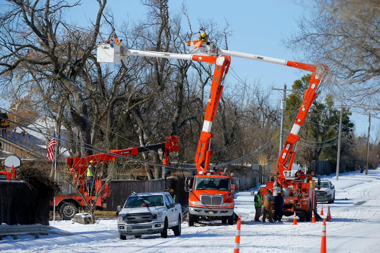 An OG&E crew works to repair a power line after a 2022 storm.  Oklahoma legislators are proposing significant changes in the way electricity rates are set and reviewed.