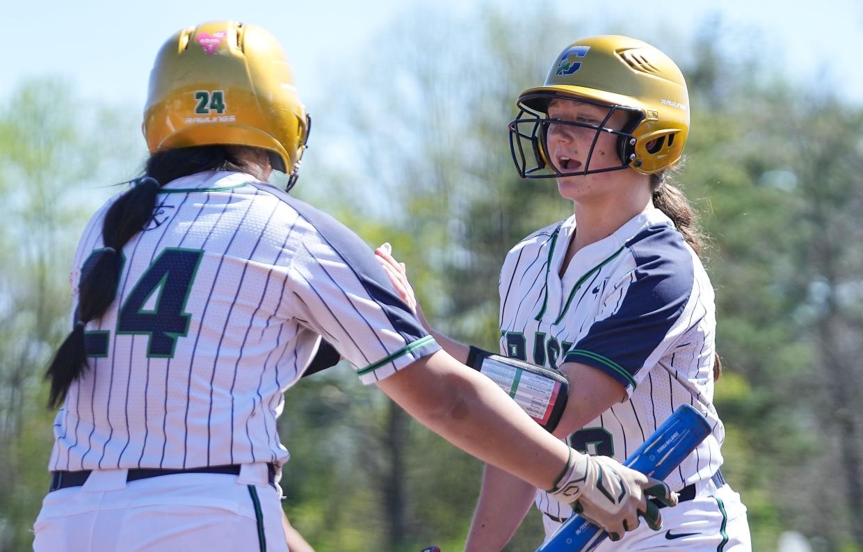 Cathedral Fighting Irish Angela Valentine (3) high-fives Cathedral Fighting Irish Aubrie Wright (24) after scoring Saturday, April 13, 2024, during the game at the Cathedral High School in Indianapolis.