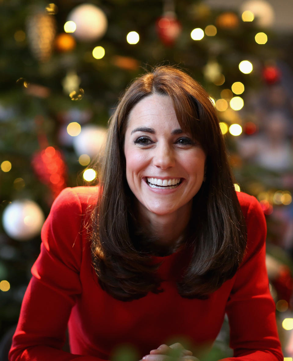 Kate donned her best smile and a custom-made Alexander McQueen dress in a festive red hue to the Anna Freud Centre Family School Christmas Party at Anna Freud Centre in London on December 15, 2015.