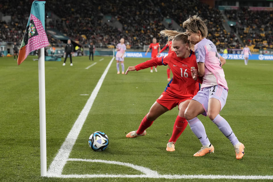 Japan's Mina Tanaka, right, and Norway's Mathilde Harviken challenge for the ball during the Women's World Cup second round soccer match between Japan and Norway in Wellington, New Zealand, Saturday, Aug. 5, 2023. (AP Photo/Alessandra Tarantino)