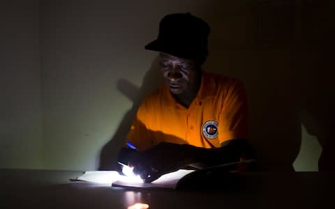 Authorities work in the planning of the emergency in a shelter hours before the arrival of hurricane Maria in Punta Cana, Dominican Republic - Credit: EPA/Orlando Barría