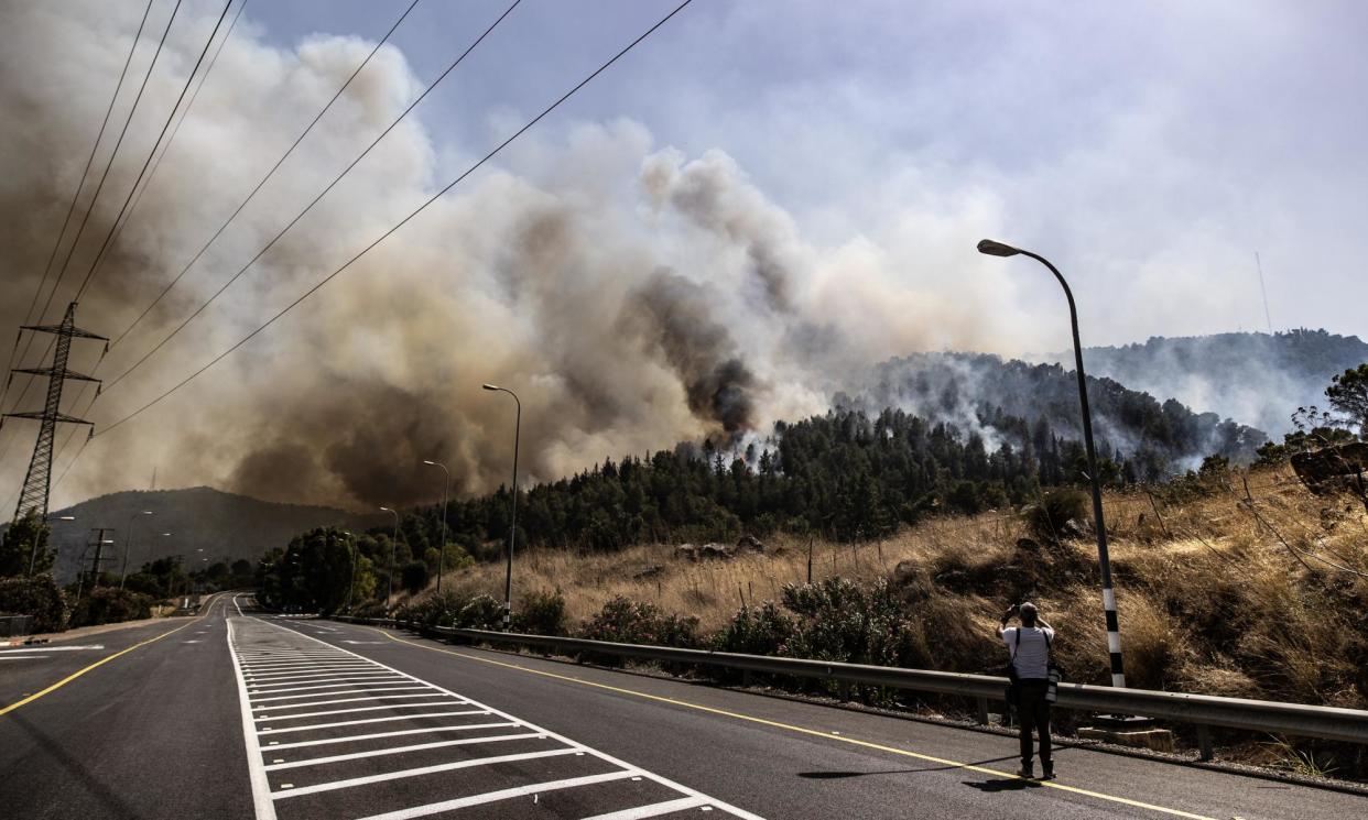 <span>Smoke rises after Hezbollah rocket attacks on a base in the town of Kiryat Shmona, Israel.</span><span>Photograph: Anadolu/Getty Images</span>