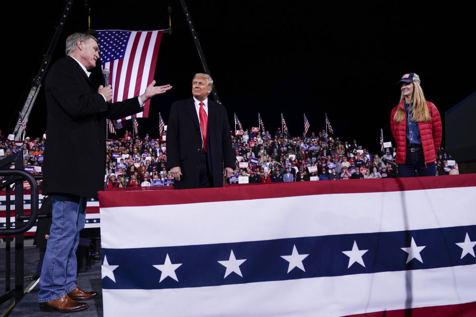 Sen. David Perdue (R-Ga., left) speaks as President Donald Trump and Sen. Kelly Loeffler (R-Ga.) listen at a campaign rally in Valdosta, Georgia, on Dec. 5. (Photo: ASSOCIATED PRESS)