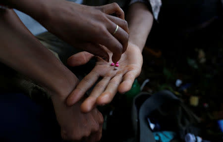 Men use drugs on a street in Man Sam, northern Shan state, Myanmar July 11, 2016. REUTERS/Soe Zeya Tun