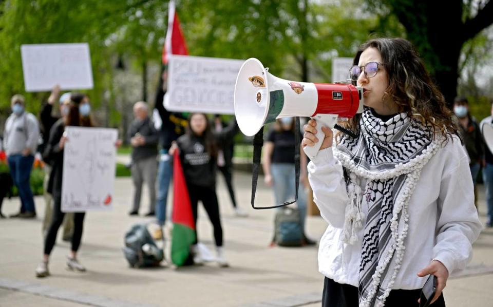 Penn State student Roua Daas speaks to the crowd outside of Old Main as they rally in support of Palestine and to call on Penn State to divest from Israel on Thursday, April 25, 2024. Abby Drey/adrey@centredaily.com