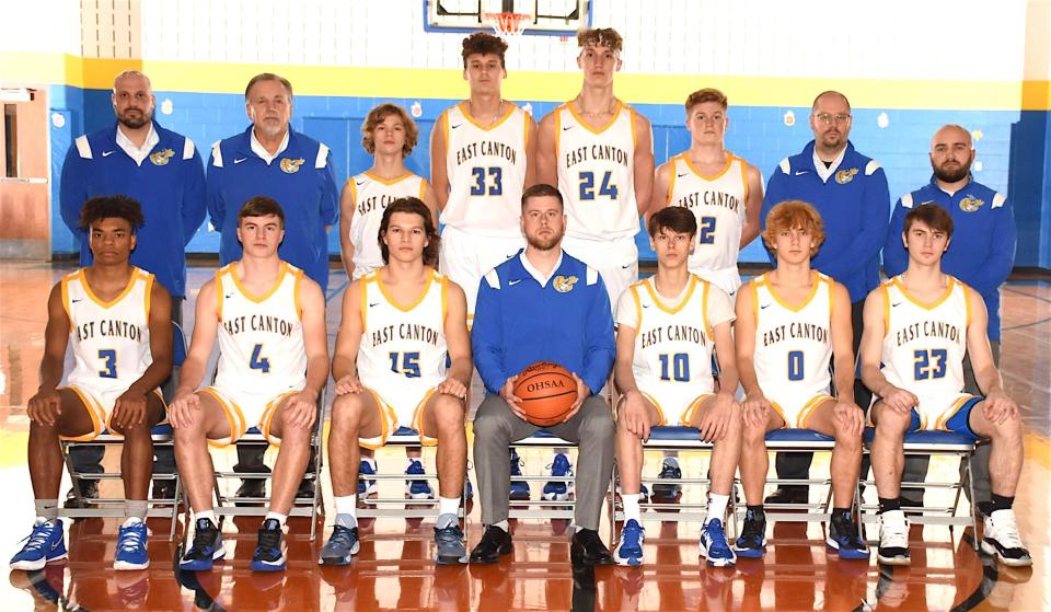 Members of the 2021-22 East Canton varsity boys basketball team are (front row, left to right) Mario Snellenberger, Luke Riley, Chase Vacco, Head Coach Ryan McGonagle, Dominic Hicks, Landen Demos and Alec Penrod; and (back row) Coach Ryan Johanning, Coach Jim Gensley, Olly Schrader, Jaedyn McLeod, Caleb Shilling, Ben Gallagher, Coach Nathan Borntrager and Coach Nathan Martin.