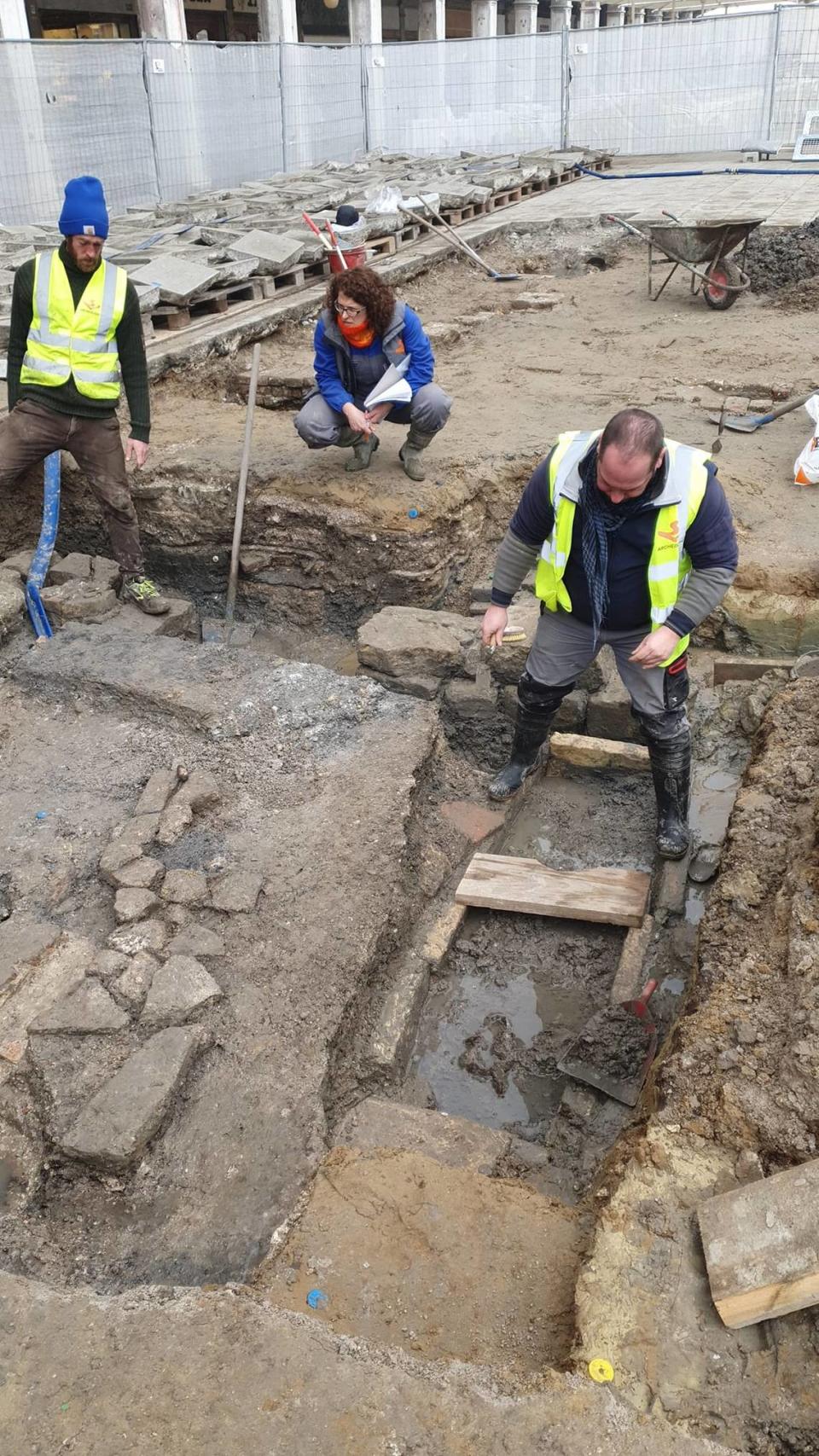 Archaeologists excavate the tomb and church ruins in the Piazza San Marco.