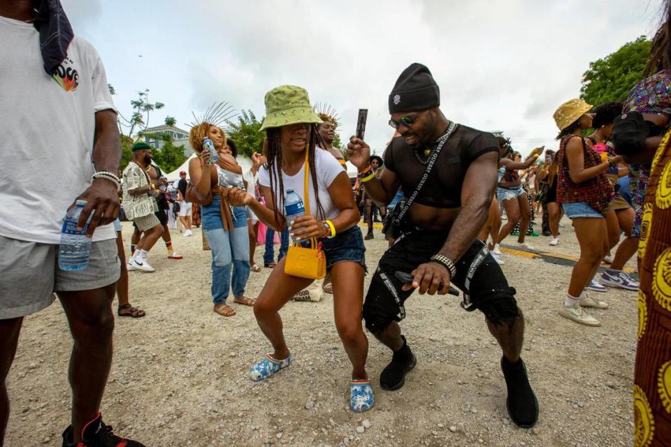 Two people dance to live music during AFROPUNK music festival at The Urban in the Historic Overtown neighborhood of Miami, Florida, on Saturday, May 21, 2022.