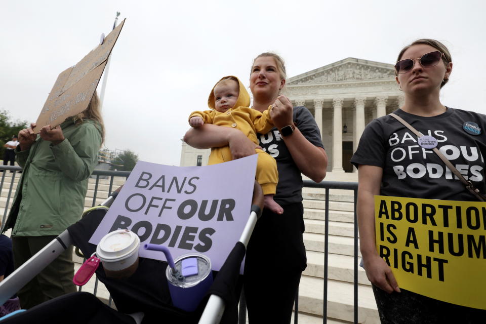 Sarah Goggans holds her four-month-old daughter Lilith Centola during a protest outside the U.S. Supreme Court, after the leak of a draft majority opinion written by Justice Samuel Alito preparing for a majority of the court to overturn the landmark Roe v. Wade abortion rights decision later this year, in Washington, U.S. May 3, 2022. REUTERS/Evelyn Hockstein