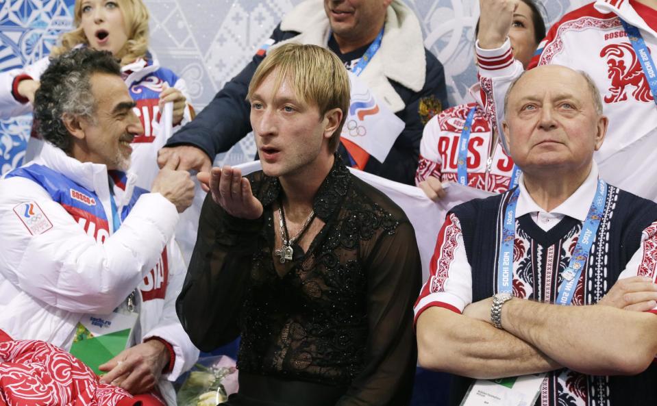 Evgeni Plushenko of Russia, centre, blows a kiss in the results area after competing in the men's team free skate figure skating competition at the Iceberg Skating Palace during the 2014 Winter Olympics, Sunday, Feb. 9, 2014, in Sochi, Russia. (AP Photo/Darron Cummings, Pool)