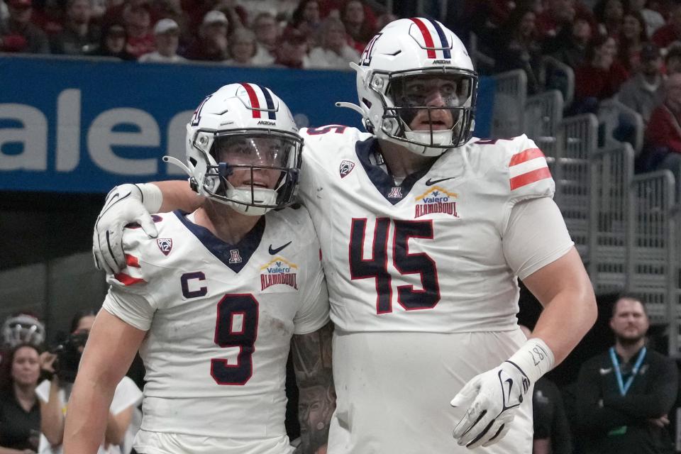 Arizona defensive lineman Bill Norton, right, celebrates during his team's win over Oklahoma in last season's Alamo Bowl. Norton, a portal target for Texas, attended Saturday's Orange-White Game.