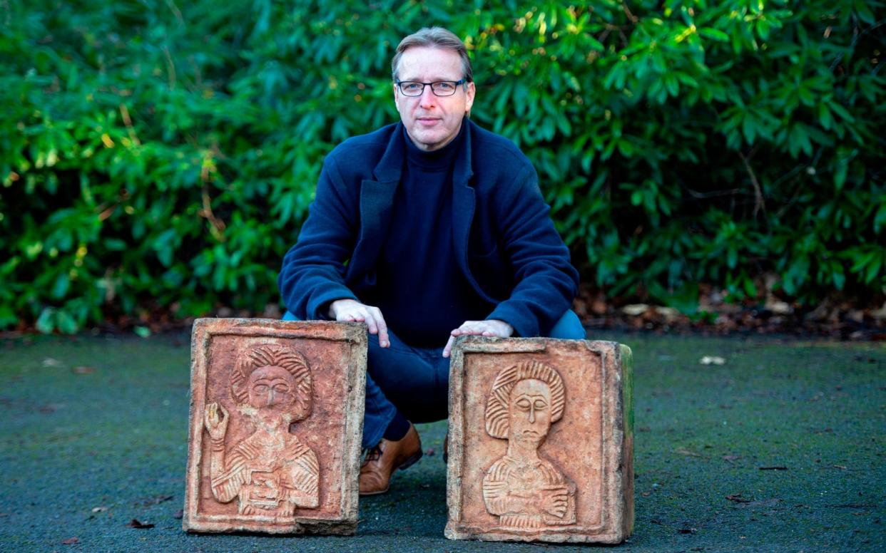 Dutch art detective Arthur Brand poses for a photograph with two limestone Visigoth reliefs from the 7th century - AFP