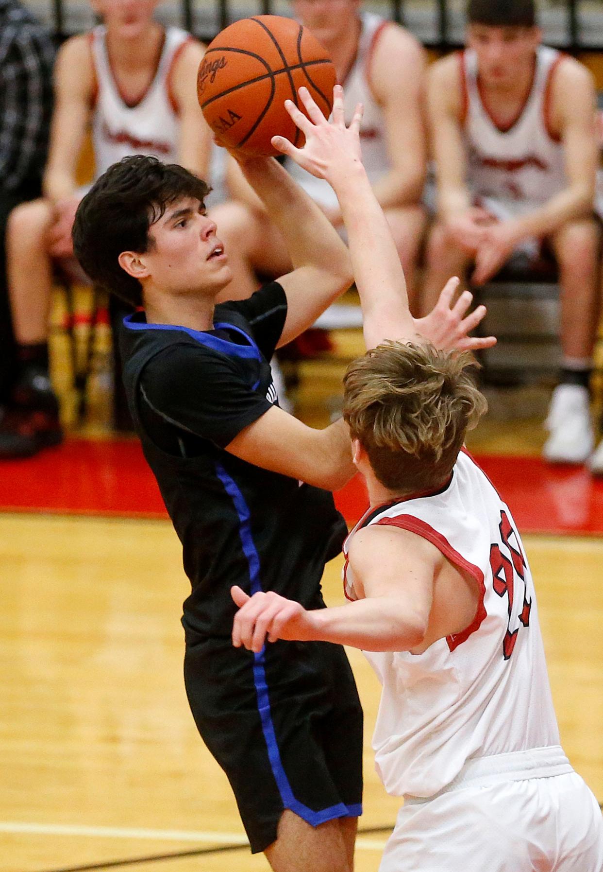 Mapleton High School's Scotty Hickey (21) puts up a shot against Crestview High School's Justice Thompson (20) during high school boys basketball action at Crestview High School Thursday, Feb. 9, 2023. TOM E. PUSKAR/ASHLAND TIMES-GAZETTE