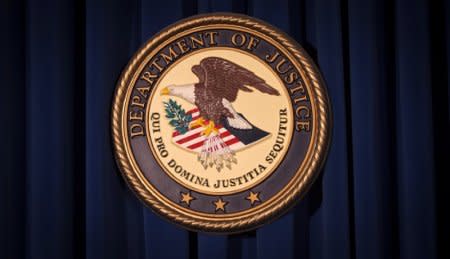 FILE PHOTO: The Department of Justice (DOJ) logo is pictured on a wall after a news conference in New York, U.S.,  December 5, 2013.     REUTERS/Carlo Allegri/File Photo