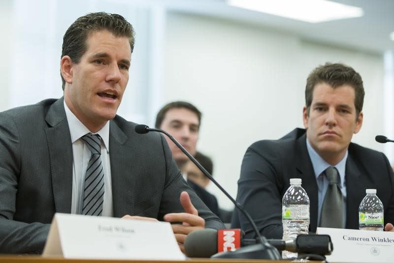 Cameron (L) and Tyler Winklevoss speaking in front of the New York Department of Financial Services in 2014 (Reuters)