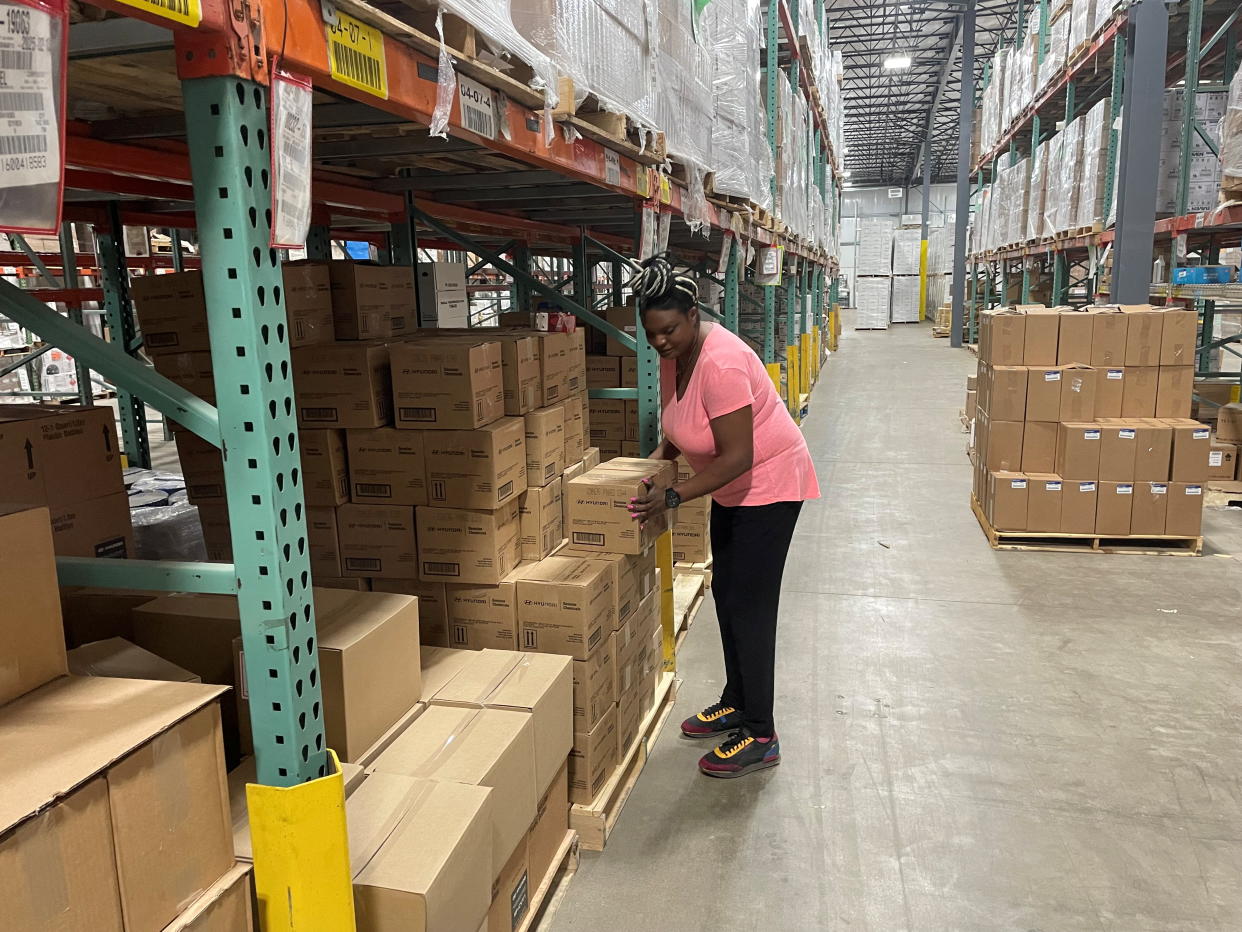 Sheila Ikenye picks boxes for a shipment at Kem Krest's warehouse in Elkhart, Indiana, U.S. March 24, 2022. Picture taken March 24, 2022. REUTERS/Timothy Aeppel