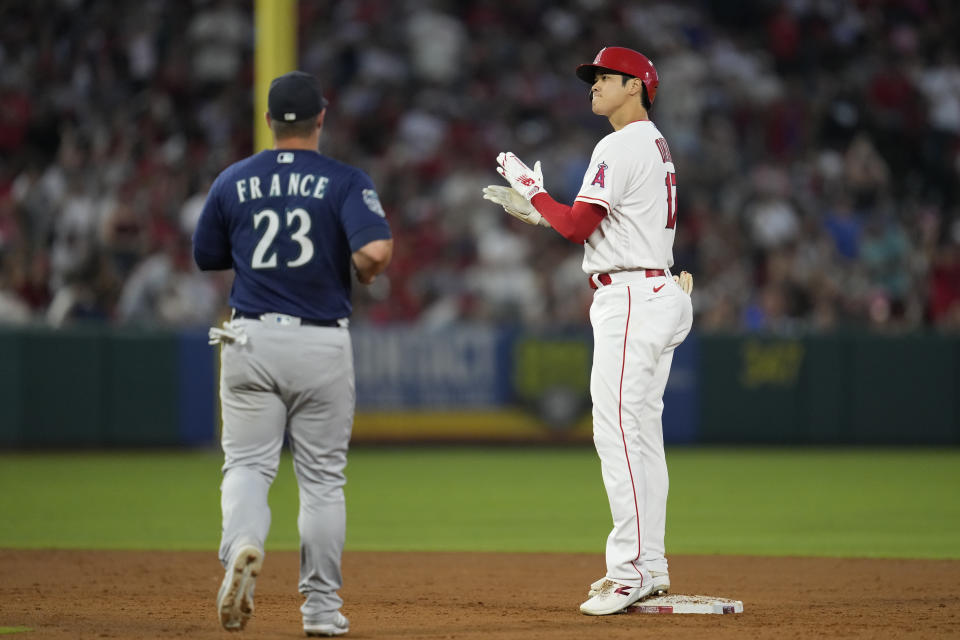 Los Angeles Angels designated hitter Shohei Ohtani (17) reacts after a double during the fourth inning of a baseball game against the Seattle Mariners in Anaheim, Calif., Friday, Aug. 4, 2023. (AP Photo/Ashley Landis)