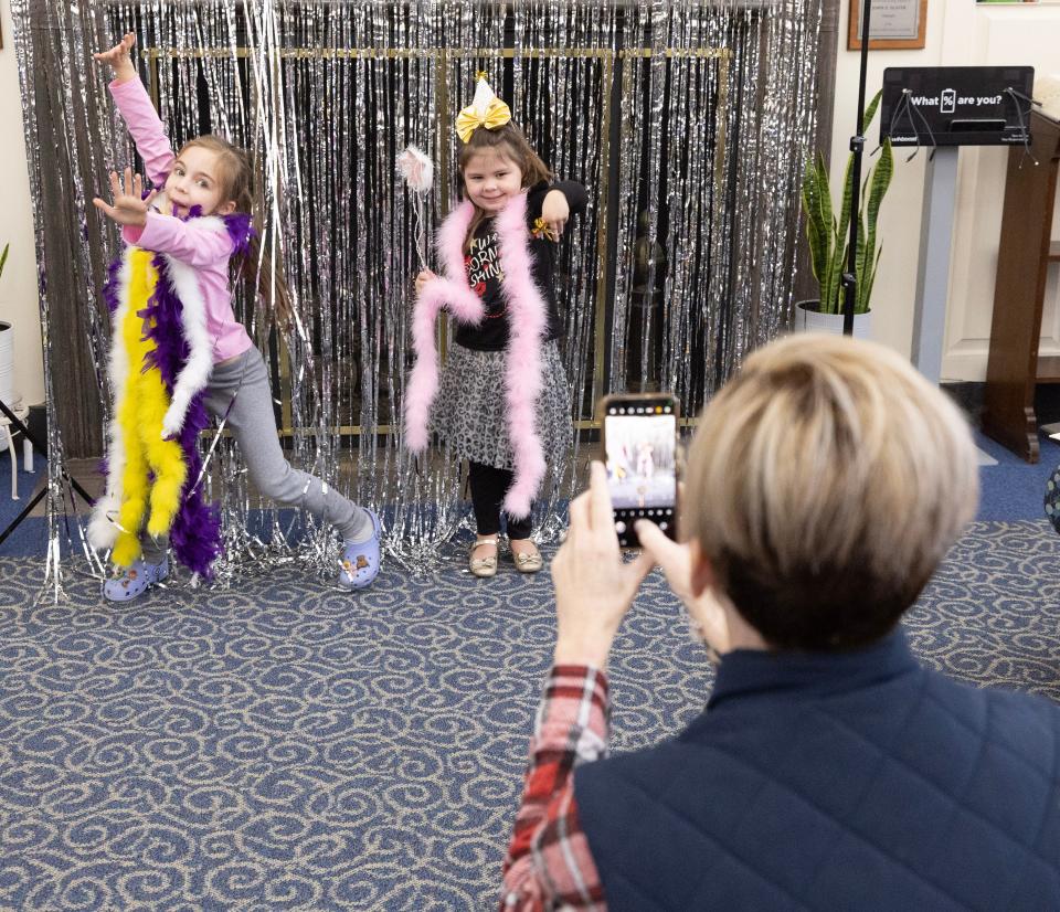 Jennifer Mayer takes a photo of her granddaughter Mary Feaser, 8, left, and friend Addison Knight, 4, at the Massillon Public Library's Noon Year's Eve Party.