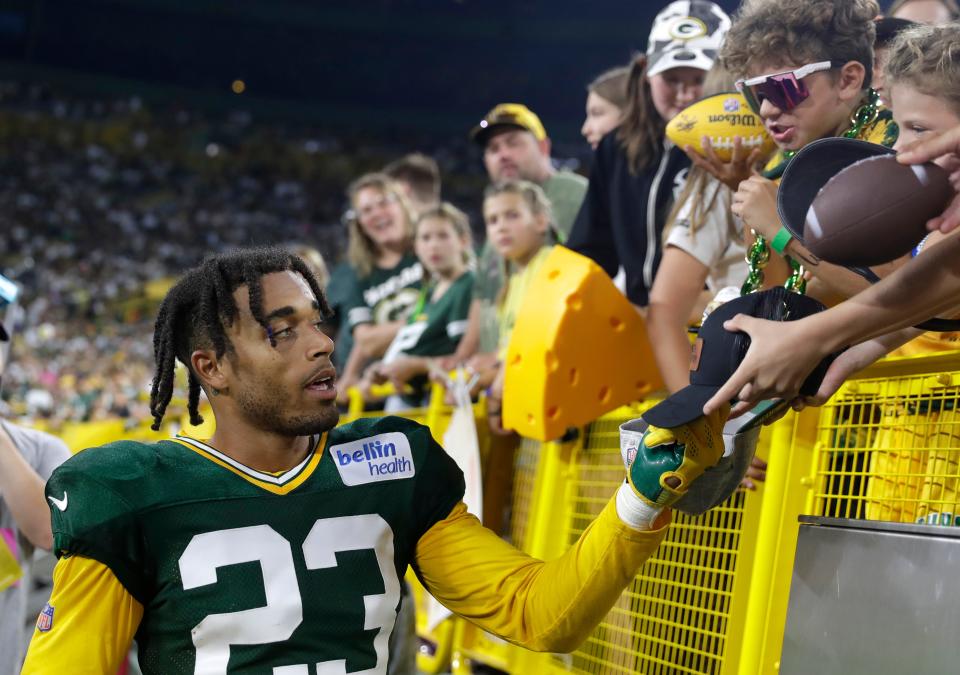 Green Bay Packers cornerback Jaire Alexander (23) signs autographs for fans during Family Night on Aug. 5, 2023, at Lambeau Field in Green Bay, Wis.