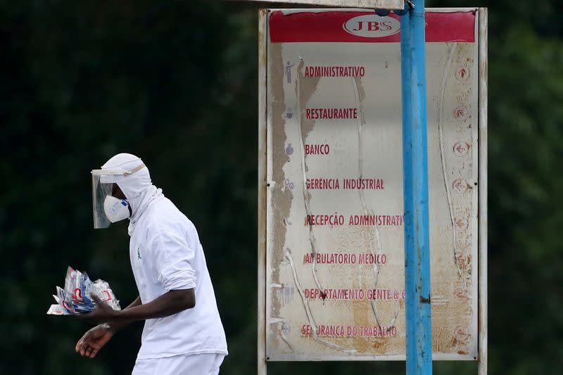 An employee of the JBS SA poultry factory walks after the company was hit by an outbreak of the coronavirus disease (COVID-19), in Passo Fundo