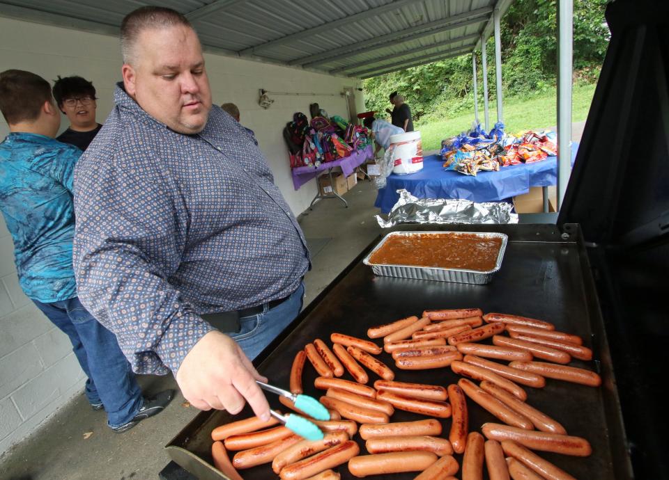 Edward Mullaly cooks up hotdogs to be given out during the annual Back to School Bash Saturday morning, July 22, 2023, at the Cherryville Church of God.