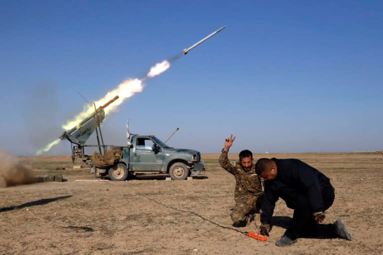 Abbas Brigade fighters fire towards enemy positions from Badush