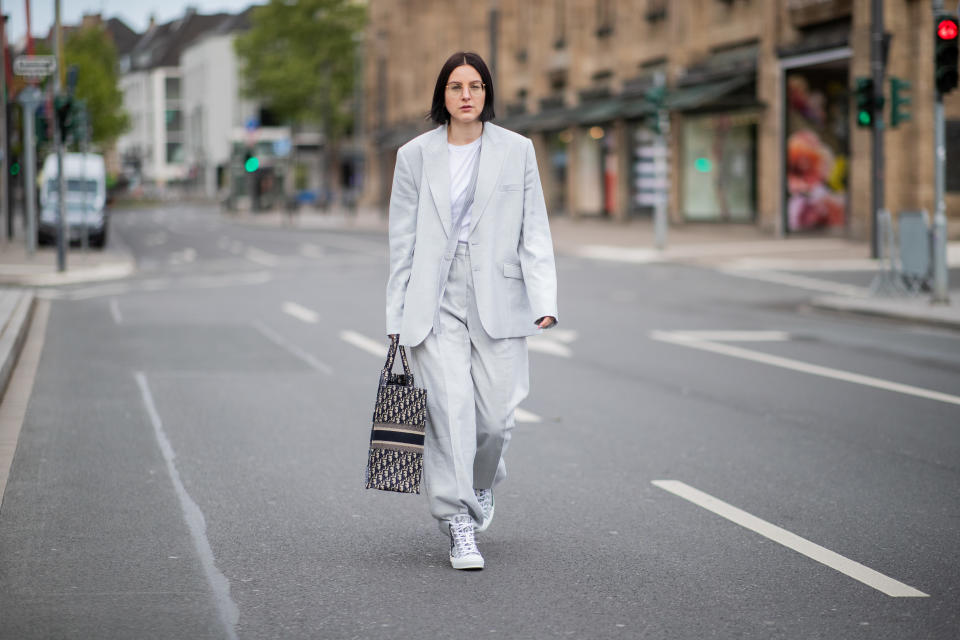 DUESSELDORF, GERMANY - MAY 05: Maria Barteczko is seen wearing grey linen oversized blazer Stella McCartney, white tshirt The Row, grey inen wide leg trousers Stella McCartney, logo book tote bag Dior, logo high top chucks Dior, round retro glasses Ray Ban, rings APM Monaco on May 05, 2019 in Duesseldorf, Germany. (Photo by Christian Vierig/Getty Images)