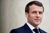 French President Emmanuel Macron waits for a guest on the steps of the Elysee palace in Paris