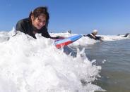 Senior women gather to boogie board on International Women's Day in Solana Beach, California