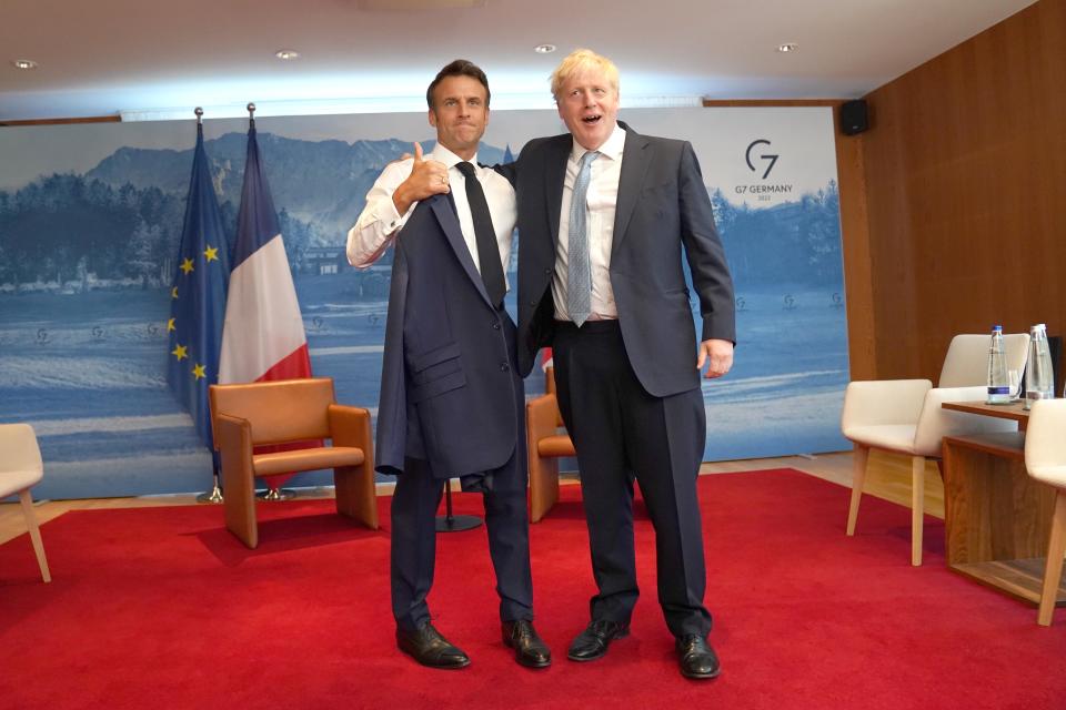 Prime Minister Boris Johnson (R) greets French President Emmanuel Macron ahead of their bilateral meeting on the first day of the three-day G7 summit at Schloss Elmau on 26 June 2022 (Getty Images)