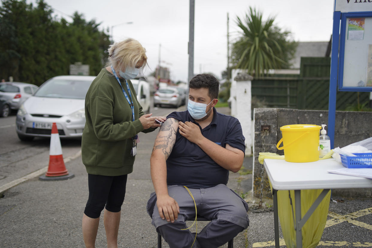 A member of the public receives a Pfizer Covid vaccination at an NHS walk-up vaccination unit outside the village hall on September 25, 2021 in the village of Summercourt, near Newquay, Cornwall, United Kingdom. (Photo by Hugh Hastings/Getty Images)