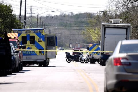 Emergency vehicles block the road after a package exploded killing a 17-year-old youth earlier this month - Credit: Reuters